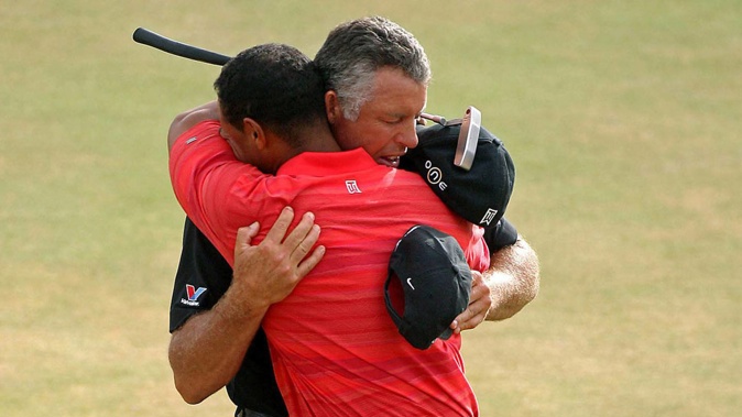Tiger Woods embraces his caddy Steve Williams after his victory in 2006. Photo / Photosport