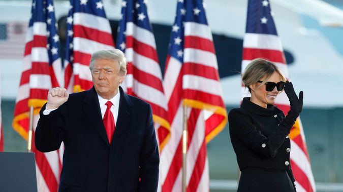 President Donald Trump and first lady Melania Trump wave to supporters after giving a speech at Andrews Air Force Base. Photo / AP
