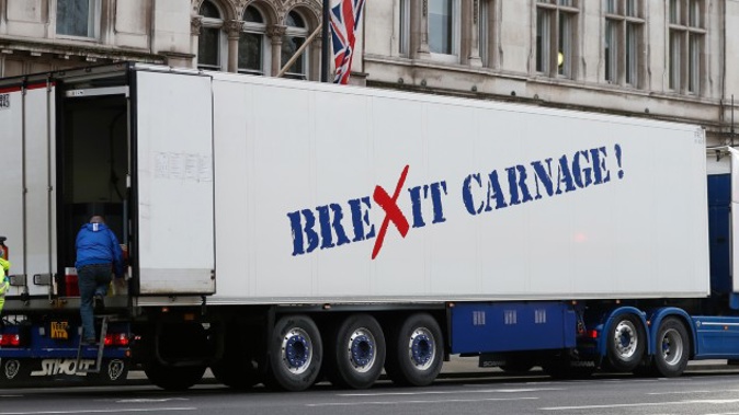 A policeman escorts the driver of a shellfish export truck as he is stopped for an unnecessary journey in London during a demonstration by British Shellfish exporters to protest Brexit-related red tape they claim is suffocating their business.(Photo / AP)