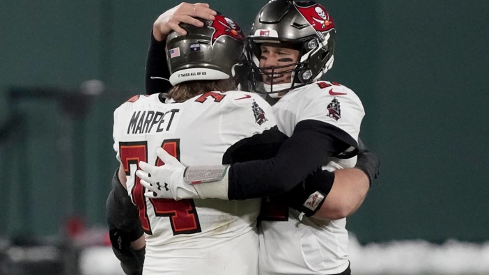 Tampa Bay Buccaneers quarterback Tom Brady (12) celebrates with Ali Marpet after winning the NFC championship NFL football game. Photo / AP