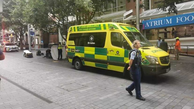 Police and St John staff were called to an incident on Elliott St, Auckland, late this morning. Photo / NZ Herald