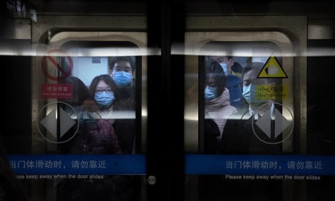 Commuters in Beijing on Wednesday. Officials reportedly took anal swabs from residents of areas with confirmed Covid cases in the capital last week. Photo / AP