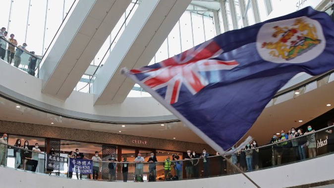 In this May 29, 2020, file photo, a protester holds a Hong Kong colonial flag in a shopping mall during a protest against China's national security legislation for the city, in Hong Kong. (Photo / AP)