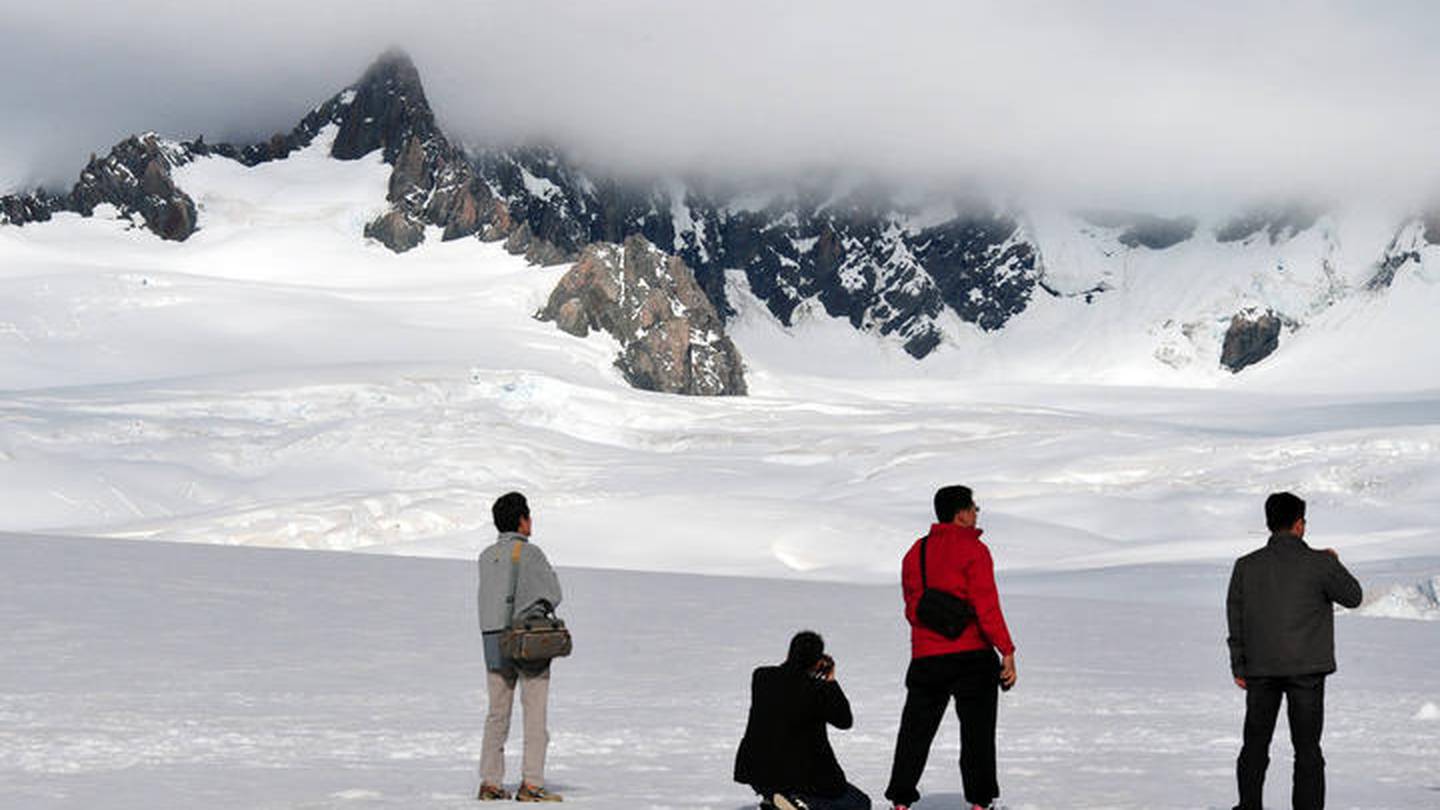 Tourists at Fox Glacier. Photo / 123RF