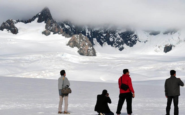 Tourists at Fox Glacier. Photo / 123RF