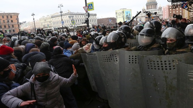 Police stand blocking approaches to the street as protesters try to break through during a protest against the jailing of opposition leader Alexei Navalny in St. Petersburg. (Photo / AP)