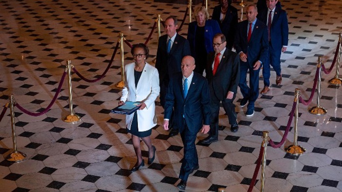 House Managers walk to the US Senate to deliver the Articles of Impeachment against US President Donald Trump. (Photo / Getty)