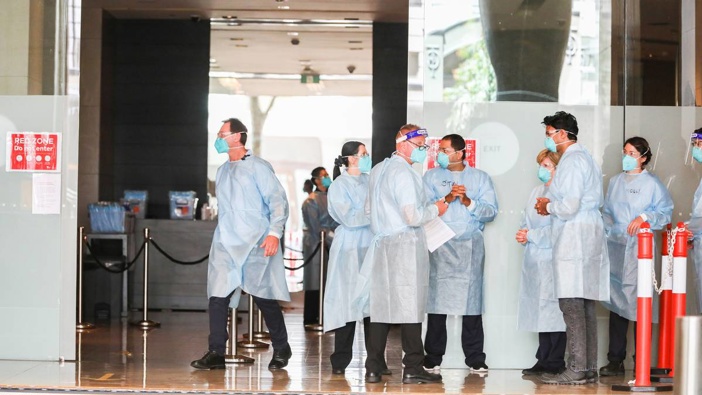 Hotel Quarantine workers wearing full PPE at the Grand Hyatt Melbourne Hotel on January 20, 2021 in Melbourne, Australia. 