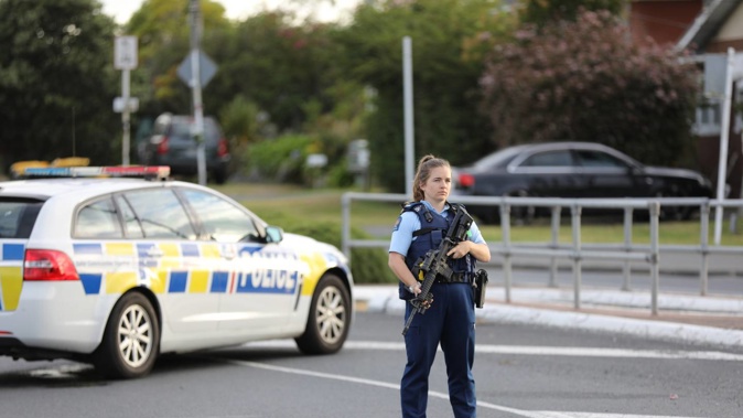 Armed police have closed Don Buck Rd in Massey, west Auckland due to an unfolding firearms incident. Photo / Hayden Woodward