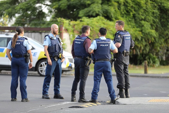 Armed police officers at the scene of a firearms incident in Massey, West Auckland. (Photo / Hayden Woodward)
