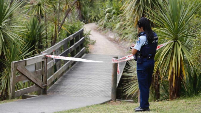 A police officer at a walkway cordon where a man was found in the water at Meola Creek, Westmere, this morning. Photo / Dean Purcell