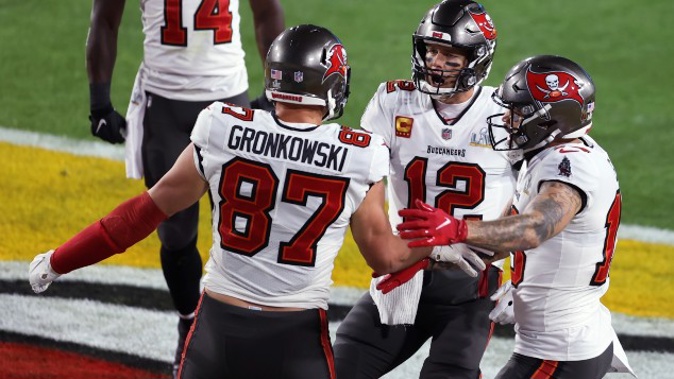 Tampa Bay Buccaneers' Rob Gronkowski (87) celebrates with Mike Evans (13) and quarterback Tom Brady (12) after Gronkowski scored a touchdown during the first half of the NFL Super Bowl 55 football game