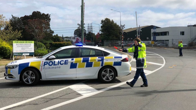 Police have cordoned off Matipo St, Riccarton, Christchurch as five fire crews deal with a shipping container hanging above LPG cylinders at a Kiwirail yard. Photo / NZ Herald