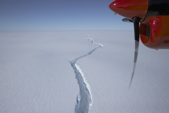 An airplane flies over the North Rift crack in the Brunt Ice Shelf in January. (Photo / British Antarctic Survey via AP)