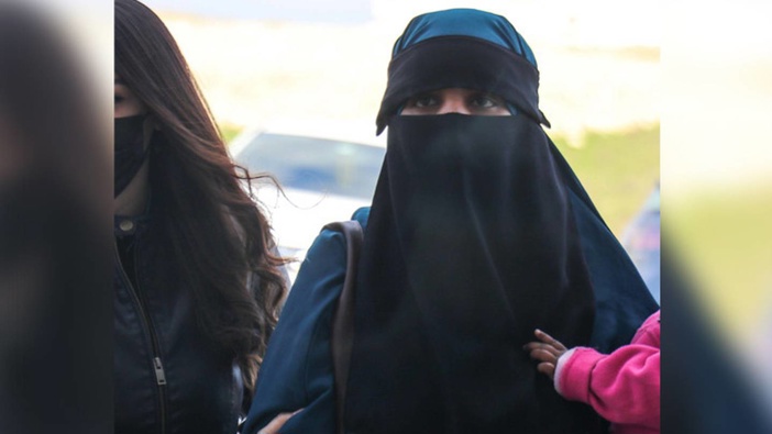 Alleged Isis terrorist Suhayra Aden, right, is escorted into court by a Turkish police officer. Photo / Getty Images