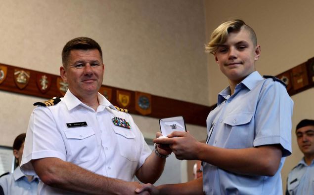 Cadet Seth Whale receives a commendation from Commander Andrew Law. Photo / George Heard