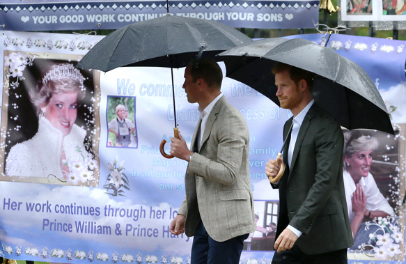 In this image, William, left, and Harry look at tributes left outside Kensington Palace to mark the 20th anniversary of Diana's death in 2017. (Photo / Getty)