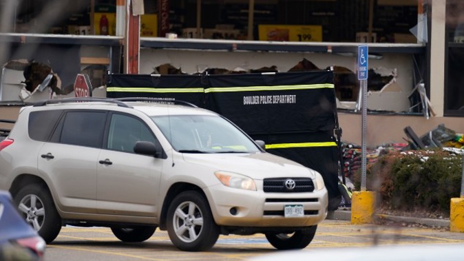 Windows appear damaged at a King Soopers grocery store where the shooting took place. (Photo / AP)