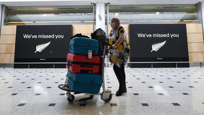 Passengers wearing facemasks arrive into the international arrivals area at Sydney's Kingsford Smith Airport from New Zealand in October. (Photo / Getty)