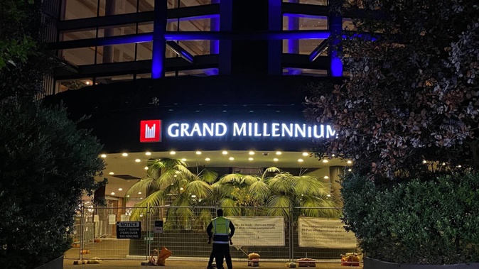 A noticeable security presence outside the Grand Millennium hotel this morning, with two guards wearing masks at the entrance. Photo / William Terite