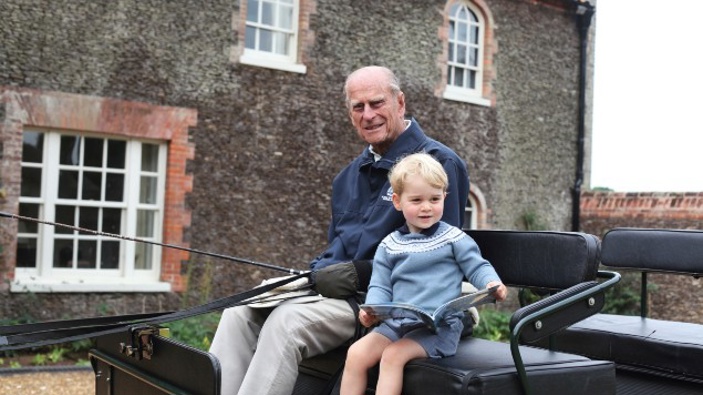 Britain's Prince Philip sits with his great-grandson Prince George in England. (Photo / AP)