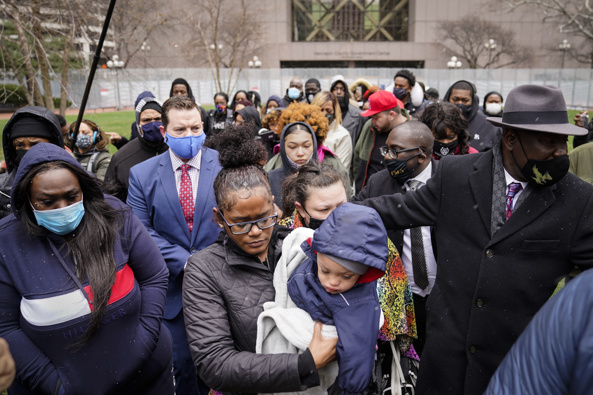 Chyna Whitaker, center, holds her son Daunte Jr., as she walks up to microphones to speak during a news conference. The father, Daunte Wright, 20, was shot and killed by police. (Photo / AP)