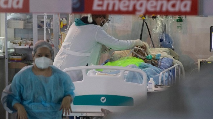 Health workers treat a COVID-19 patient at the emergency unit of a field hospital set up to treat COVID patients in Ribeirao Pires, greater Sao Paulo area, Brazil.