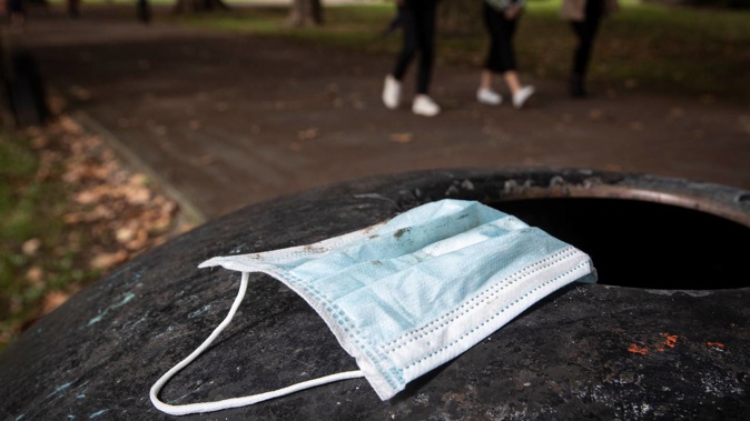 People are being urged not to retreive used face masks from bins but rather use a scarf or t-shirt as a make shift face covering while on public transport. Photo / Jason Oxenham.