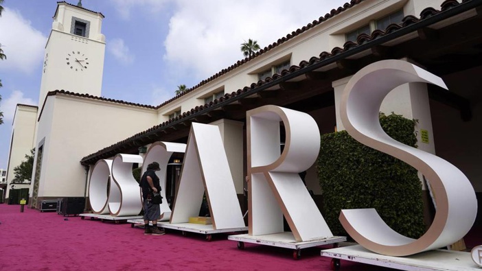 An Academy Awards crew member looks over a background element for the red carpet at Union Station. Photo / AP