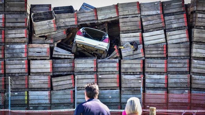 The car became lodged in the crates after fleeing police. Photo / Ian Cooper