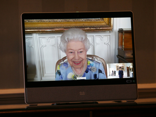Queen Elizabeth II appears on a screen by video link from Windsor Castle.