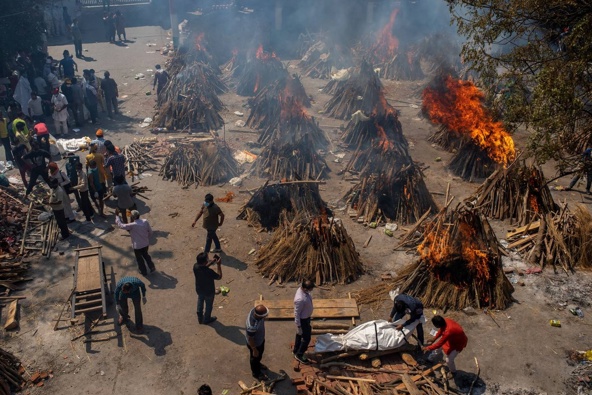 Multiple funeral pyres of victims of Covid-19 burn at a ground that has been converted into a crematorium for mass cremation in New Delhi. Photo / AP