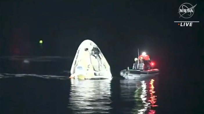In this image made from NASA TV video, the SpaceX Dragon capsule floats after landing in the Gulf of Mexico near the Florida Panhandle 