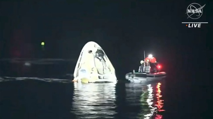 In this image made from NASA TV video, the SpaceX Dragon capsule floats after landing in the Gulf of Mexico near the Florida Panhandle