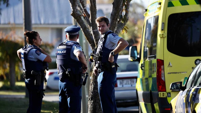 Armed police and emergency services are at the scene of an incident in Christchurch this afternoon. (Photo / George Heard)