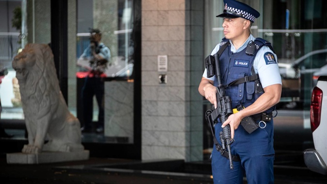 Armed police stand guard outside the Sofitel Auckland hotel on Auckland's Viaduct in response to a firearms incident on April 15. (Photo / Jason Oxenham)