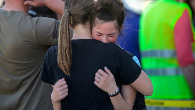 Students embrace after a school shooting at Rigby Middle School. (Photo / AP)