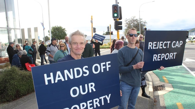 Tim Rees (front) was among a group of protesters outside Kāpiti Coast District Council headquarters in Paraparaumu on Thursday. Photo / David Haxton