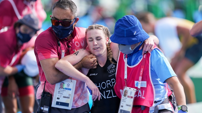 Ainsley Thorpe of New Zealand is helped to leave on Mixed Relay Triathlon during the Tokyo 2020 Olympic Games at the Odaiba Marine Park on July 31, 2021 in Tokyo, Japan. Photo / Getty