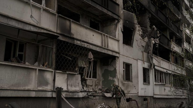 A Ukrainian serviceman inspects a heavily damaged apartment building after Russian bombardment in Kharkiv, Ukraine on Sunday, April 24, 2022. Photo / AP