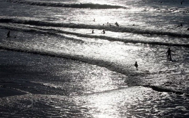 People swim in the Atlantic Ocean in Biarritz, southwestern France. Photo / AP