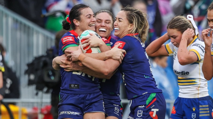 Tysha Ikenasio celebrates her second-half try with Warriors teammates Michaela Brake and Apii Nicholls. Photo / Photosport