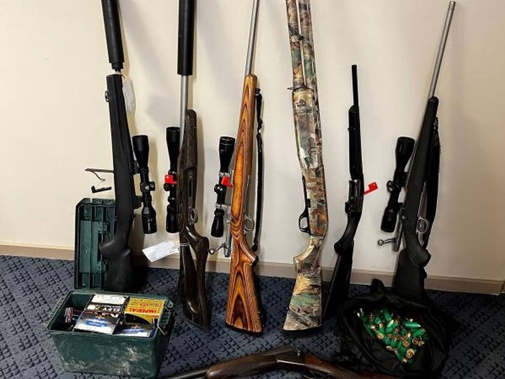 Twenty-one firearms and hundreds of rounds of ammunition were recovered by the afternoon. Photo / NZ Police