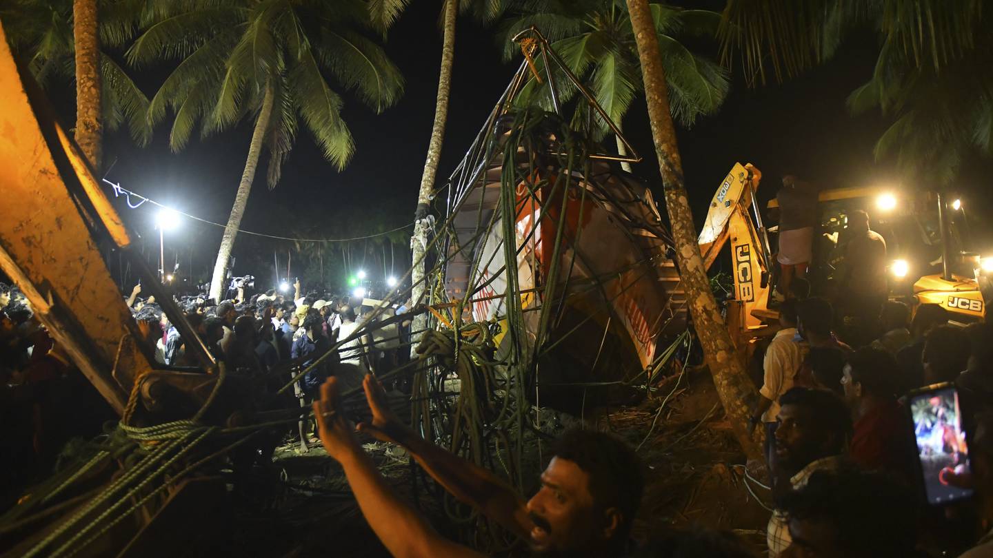 Rescuers and others gather as they pull ashore a tourist boat that capsized. Photo / AP