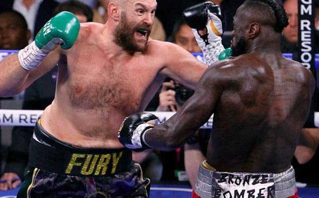 Tyson Fury and Deontay Wilder battle in the first round of their WBC heavyweight title fight. (Photo / Getty)