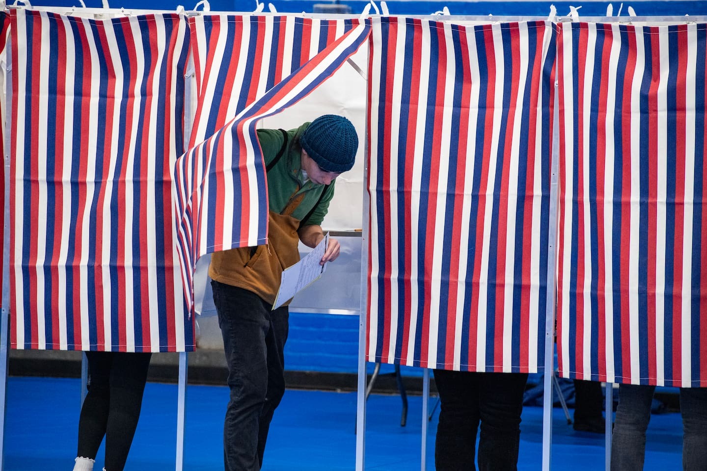 A person exits a voting booth after filling out their ballot at the Green Street Community Center in Concord, New Hampshire. Photo / AFP