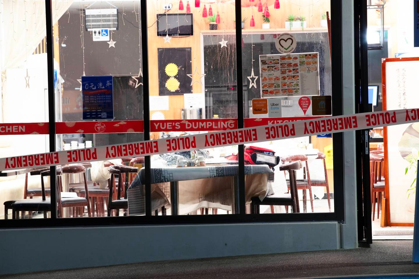 Police tape surrounds one of the restaurants on Corinthian Drive, in Albany, where a number of people were attacked, allegedly by a man wielding a log splitting axe. Photo / Hayden Woodward
