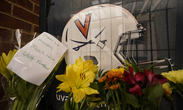 Memorial flowers and notes line walkway at Scott Stadium after three football players were killed in a shooting on the grounds of the University of Virginia Tuesday Nov. 15, 2022, in Charlottesville. Va. Photo / AP