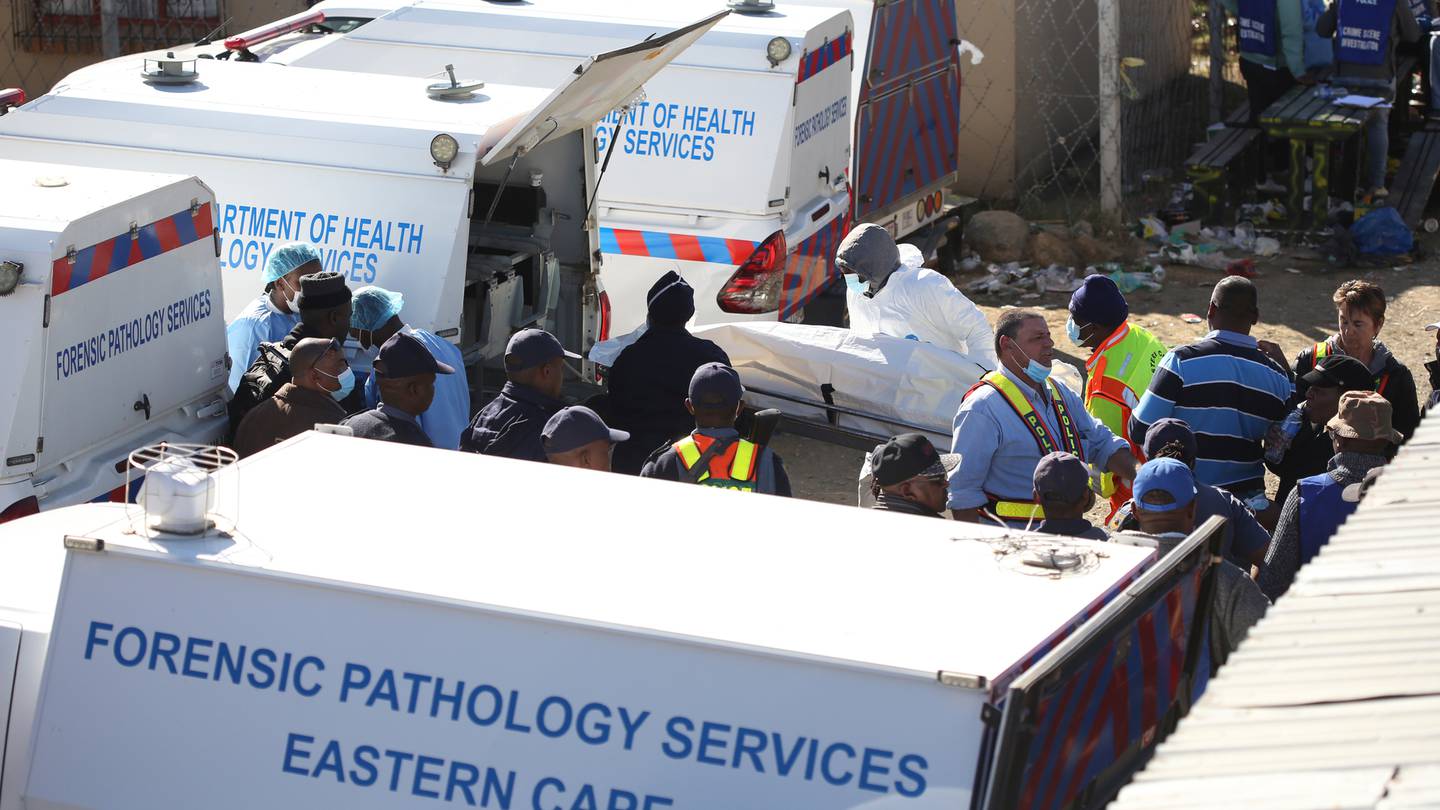 A body being removed from a nightclub in East London, South Africa, one of 21 people who died. Photo / AP, File