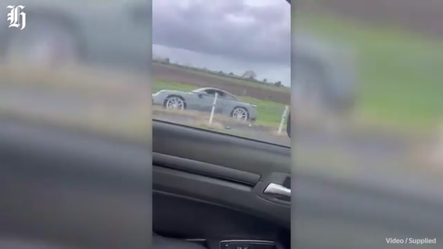 An alleged stolen Porsche is driven along the embankment of the Waikato Expressway on Sunday morning.